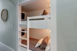 Bunk beds off the hallway with 32 smart televisions
